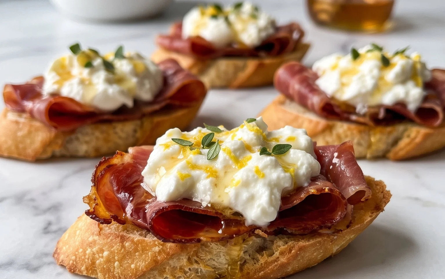 Beef Prosciutto Crostini with Burrata and Lemon Honey Drizzle